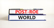 Roe vs Wade post-Roe world symbol. Concept words Post-Roe world on books on a beautiful white table white background. Business and Roe vs Wade post-Roe world concept. Copy space.