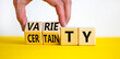 Variety or certainty symbol. Concept words Variety or certainty on wooden cubes. Businessman hand. Beautiful yellow table white background. Business variety or certainty concept. Copy space.