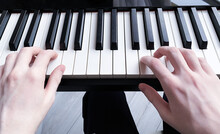 Hands Of A Young Pianist On The Keys Of A Piano Instrument