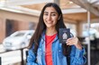 © Krakenimages.com - Young teenager girl holding canada passport looking positive and happy standing and smiling with a confident smile showing teeth
