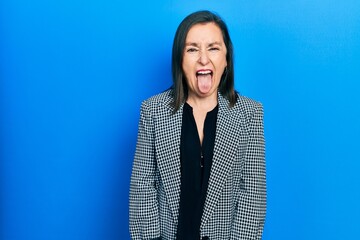 Poster - Middle age hispanic woman wearing business clothes sticking tongue out happy with funny expression. emotion concept.