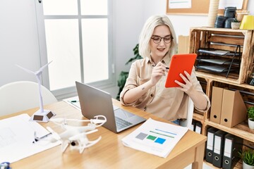 Poster - Young caucasian woman using touchpad working at office