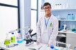 © Krakenimages.com - Down syndrome man wearing scientist uniform standing at laboratory