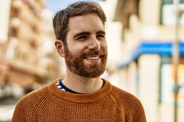 Wall Mural - Young caucasian man with beard outdoors on a sunny day