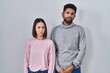 © Krakenimages.com - Young hispanic couple standing together skeptic and nervous, frowning upset because of problem. negative person.
