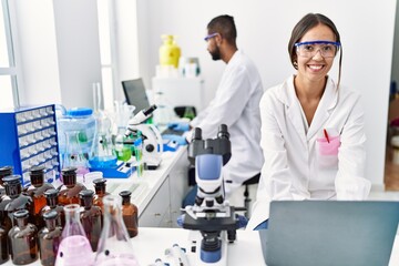 Wall Mural - Man and woman scientist partners smiling confident working at laboratory