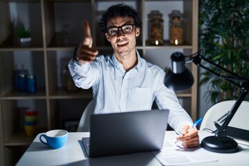 Sticker - Hispanic man working at the office at night pointing fingers to camera with happy and funny face. good energy and vibes.