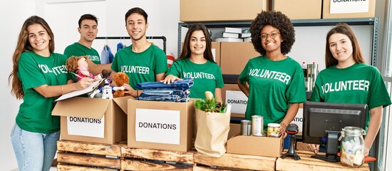 Group of young volunteers smiing happy working at charity center.