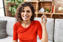 Young Latin Woman Smiling Confident Holding Key Of New House At Home
