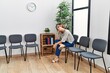 © Krakenimages.com - Young caucasian girl bored sitting on the chair at waiting room.