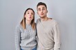 © Krakenimages.com - Young hispanic couple standing over white background making fish face with lips, crazy and comical gesture. funny expression.