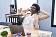 © Krakenimages.com - Young african american woman business worker relaxed with hands on head at office