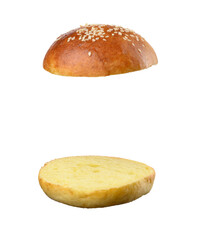 Two halves of a bun made of white wheat flour with sesame seeds isolated on a white background