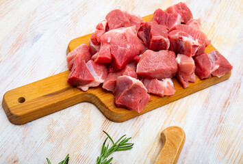 Wall Mural - Close up of uncooked chopped pork on wooden background