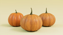 Three Pumpkins On A Pale Yellow Colored Background. Fall Themed Wallpaper.