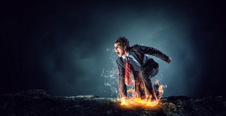 Wall Mural - Determined businessman leaving fire trails on asphalt