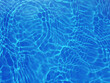 Blurred transparent blue colored clear calm water surface background. Water is an inorganic, transparent, tasteless, odorless, and nearly colorless chemical substance, which is the main 