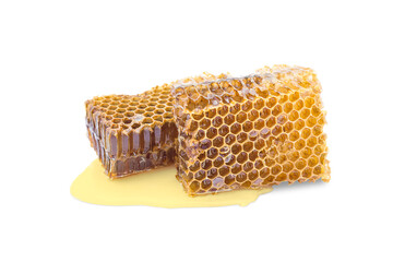 Wall Mural - Two pieces of beeswax with honey and spilled honey on a white background