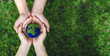 © Deemerwha studio - Many hands person holding the earth on a green background to protect nature Save and care World for sustainable. concept of the environment ecology and Earth Day