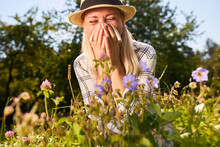 Woman With Hay Fever In A Flowering Meadow