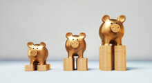 Golden Piggy Bank Standing On Golden Stacks Of Coins