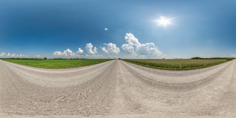 Wall Mural - 360 hdri panorama on no traffic gravel dusty road among fields with fluffy clouds in full seamless s