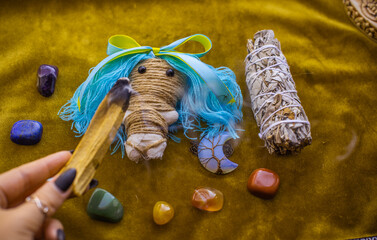 Magic doll for attracting love, rite with voodoo and fate creation, details on a table of witch, occultism concept 