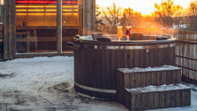 Hot Outdoor Wooden Bath Tub On Terrace Of Private House. Finnish Sauna