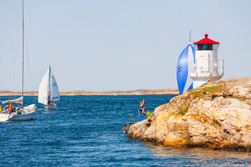 Canvas Print - Children jump from a cliff into the sea