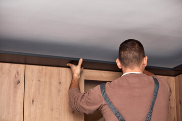 Sticker - Handyman making kitchen wall cabinets in the apartment.