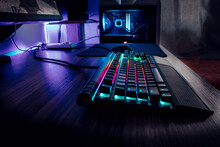Professional Gaming Desk With RGB Lights, Led Keyboard And Purple Reflexions Making A Beautiful Setup For Gamers, Computer Enthusiasts And Streaming Producers