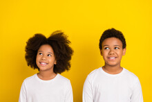 Photo Of Two Minded Positive Pupils Look Interested Empty Space Dream Isolated On Yellow Color Background