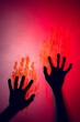 © vectorfusionart - Composition of shape of black hands with blood stains on red background