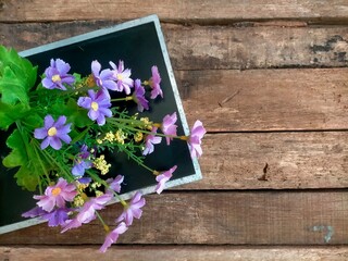 Wall Mural - flowers on wooden background