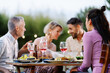 © EFStock - Friends having gossip conversation telling whisper secret during summer dinner outdoors