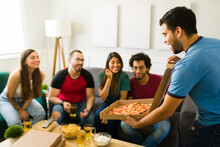 Group Of Friends Hanging Out And Eating Pizza Together