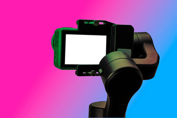 action camera on gimbal stabilizer, isolated on colourful background