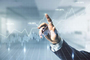 double exposure of man hand clicks on abstract creative financial chart hologram on blurred office b