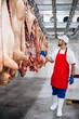 © Petro - Man butcher standing in meat freezer holding hook