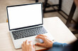 © panitan - computer screen blank mockup.hand woman work using laptop with white background for advertising,contact business search information on desk at coffee shop.marketing and creative design