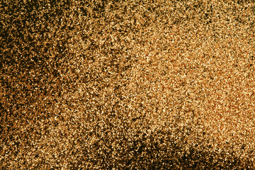 Wall Mural - Gold and bronze glitter color confetti dots splash on black. Abstract glow shine background.