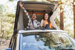 © Sabrina - Multiethnic female friends having fun during mini van camper vacation at mountain forest