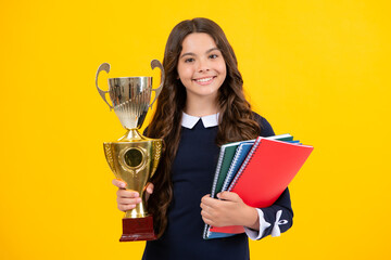 teenager school girl with award winner trophy. child hold books with gold trophy or winning cup isol