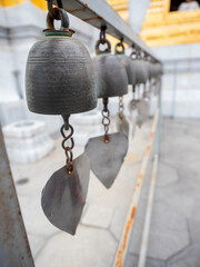 Wall Mural - small iron bell for decorate in Thai temple and blur background