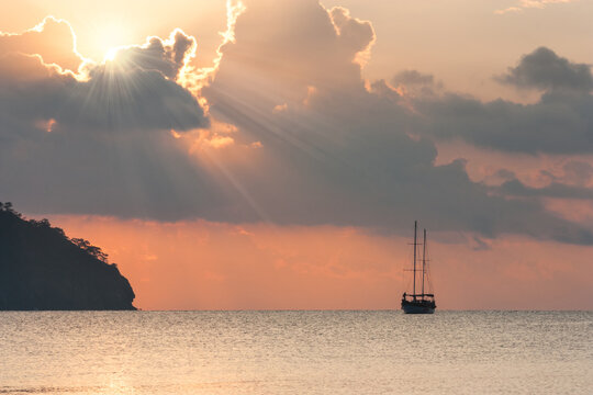 Beautiful seascape - view of morning sea with a sailboat in the bay of Adrasan, coast of the Mediterranean Sea, Antalya Province, Turkey.