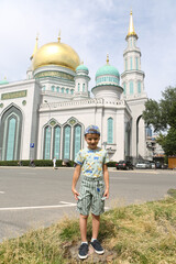 Wall Mural - Tourist boy, cute child, fashion kid and Moscow Cathedral Mosque in Moscow city, Russia. Child and Moscow landmark, monument, sight, view. Islamic, muslim architecture 