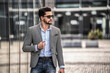 © neonshot - Handsome young well-dressed man wearing fashionable sunglasses and clothes, posing outdoor. Businessman.