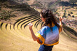 Woman on farming terraces at Inca ruins at Pisac in the Sacred Valley in Cusco, Peru