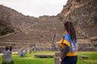 Woman entering Inca ruins at Ollantaytambo in the Sacred Valley in Cusco, Peru