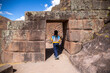 Woman entering Inca ruins at Pisac in the Sacred Valley in Cusco, Peru